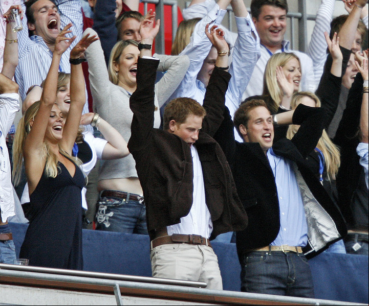 Harry, su novia y su hermano William, durante un recital en Wembley. Foto: AFP