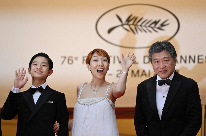 Los intérpretes Soya Kurokawa y Sakura Ando acompañan al ya ganador de la Palma, Hirokazu Kore-eda, en la entrada a la Sala Lumière. Foto AFP